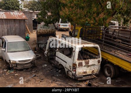 Yard Hosting Abandoned Vehicle Wrecks of Rust-Encrusted Trucks, Mini-Bus, and Light Car Stock Photo