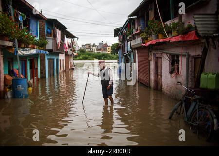 200721 -- BEIJING, July 21, 2020 -- A man makes his way through flood water in Kathmandu, Nepal on July 20, 2020. Photo by /Xinhua XINHUA PHOTOS OF THE DAY SulavxShrestha PUBLICATIONxNOTxINxCHN Stock Photo