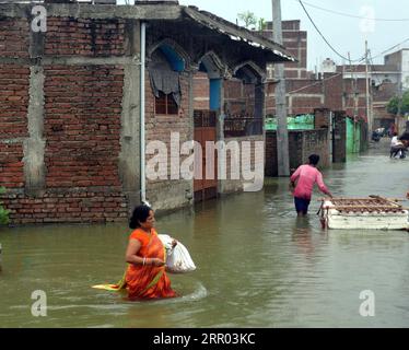 200726 -- BIHAR INDIA, July 26, 2020 -- Villagers wade through flood water in a village of Muzaffarpur district, India s eastern state of Bihar, July 26, 2020. At least 10 people were killed and nearly 1.5 million people were affected by floods in 11 districts in India s eastern state of Bihar, the state disaster management department said in a bulletin on Sunday. Str/Xinhua INDIA-BIHAR-FLOODS ParthaxSarkar PUBLICATIONxNOTxINxCHN Stock Photo