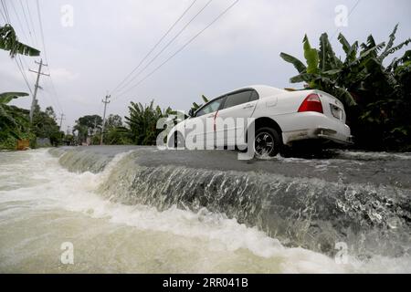 200727 -- MUNSHIGANJ, July 27, 2020 Xinhua -- A car goes along a flooded road in Munshiganj on the outskirts of Dhaka, capital of Bangladesh, on July 27, 2020. Almost half of Bangladesh remained in the grip of floods on Monday with scores of casualties reported. According to the daily flood situation report of the country s disaster response coordination center, the floods have killed 119 people in 21 out of 64 districts since June 30. Xinhua BANGLADESH-MUNSHIGANJ-FLOOD PUBLICATIONxNOTxINxCHN Stock Photo