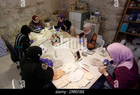 200729 -- NABLUS, July 29, 2020 Xinhua -- Palestinian women work on artifacts during a ceramic art course in Nisf Jubeil village, west of the West Bank city of Nablus, on July 28, 2020. Inspired by Palestinian culture and landscapes, a group of Palestinian women make ceramic artifacts to support their families. Photo by Ayman Nobani/Xinhua MIDEAST-NABLUS-CERAMIC-ARTIFACTS PUBLICATIONxNOTxINxCHN Stock Photo