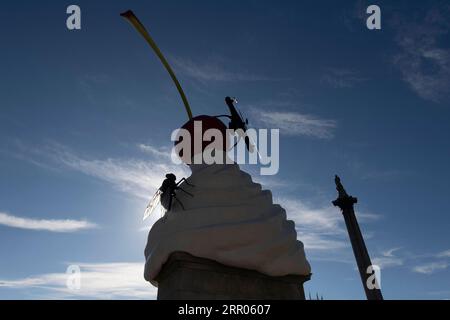 200730 -- LONDON, July 30, 2020 Xinhua -- Photo taken on July 30, 2020 shows the Fourth Plinth sculpture titled The End at Trafalgar Square in London, Britain. A new artwork by artist Heather Phillipson was unveiled Thursday on the Fourth Plinth in London s Trafalgar Square. Entitled THE END, the sculpture tops the Fourth Plinth with a giant swirl of whipped cream, a cherry, a fly and a drone that transmits a live feed of Trafalgar Square. Photo by Ray Tang/Xinhua BRITAIN-LONDON-FOURTH PLINTH SCULPTURE-UNVEILING PUBLICATIONxNOTxINxCHN Stock Photo