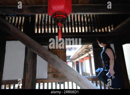 200802 -- FUZHOU, Aug. 2, 2020 -- A woman visits Honglincuo in Xinhu Village, Bandong Township of Minqing County in southeast China s Fujian Province, July 17, 2020. Honglincuo is a well-preserved ancient dwelling compound in Xinhu Village of Fujian Province. The word cuo means dwelling place, house or small village in Fujian dialect. The family of Huang started to build the dwelling in 1795. Completed in 1823, the compound covers an area of about 17,832 square meters and has 35 halls, 666 rooms and 25 gardens. Designed and built as a whole structure, the spacious Honglincuo displays a high-le Stock Photo