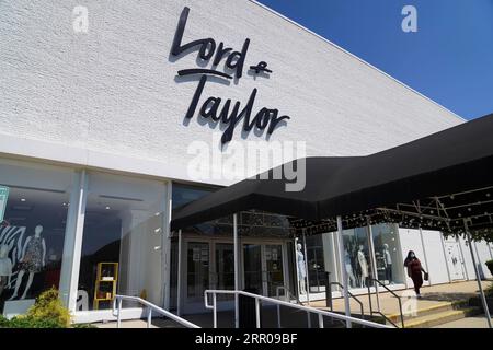 200804 -- BEIJING, Aug. 4, 2020 -- A woman walks past a Lord & Taylor store in Long Island, New York, the United States, on Aug. 3, 2020. Lord & Taylor, one of America s oldest department stores, filed for bankruptcy protection on Sunday, joining a growing list of stores slammed by the COVID-19 pandemic.  XINHUA PHOTOS OF THE DAY WangxYing PUBLICATIONxNOTxINxCHN Stock Photo