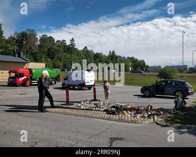 200804 -- STOCKHOLM, Aug. 4, 2020 Xinhua -- Local people gather and mourn near to the site where a 12-year-old girl was killed after being hit by a stray bullet in a gang shooting at a petrol station car park in Norsborg, south of Stockholm, Sweden, Aug. 4, 2020. Sweden s Minister for Home Affairs Mikael Damberg vowed on Tuesday to tackle gang-related crimes following the recent tragic death of a 12-year-old girl. According to Swedish Television, the shooting was part of an escalating conflict between gangs fighting over local drug markets. Xinhua SWEDEN-STOCKHOLM-GANG SHOOTING-GIRL PUBLICATIO Stock Photo