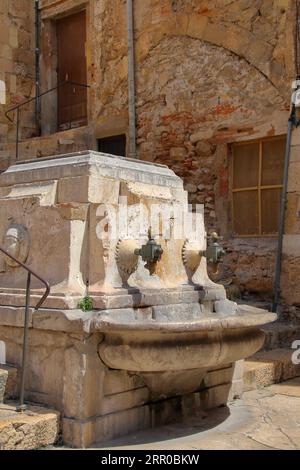 The photo shows old brass taps for water in the ancient Spanish city of Tarragona. Stock Photo