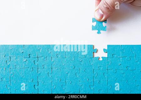 The missing piece of puzzle, success, teamwork and finishing or ending. Concept searching a solution for a problem. the missing puzzle. concept of sol Stock Photo