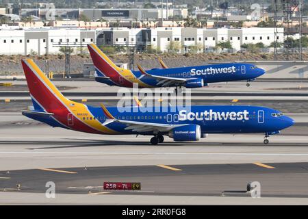 Two Southwest Airlines 737s, one landing and one taking off. Stock Photo