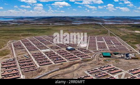 200820 -- GOLOG, Aug. 20, 2020 -- Aerial photo taken on Aug. 19, 2020 shows a view of Ghadan Village of Machali Township, Madoi County, Golog Tibetan Autonomous Prefecture, northwest China s Qinghai Province. As of October 2018, a total of 1,036 registered poverty-stricken residents have moved from Madoi County s less hospitable lands to Ghadan, a relocation village newly built within the Yellow River source area. The new village has better transportation which makes it easier for villagers to find jobs or start businesses in other towns. Meanwhile, many villagers get paid as environmental pro Stock Photo