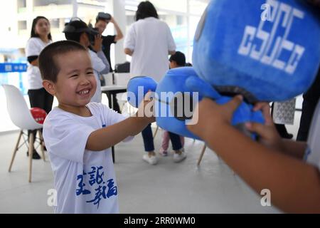 200827 -- LANZHOU, Aug. 27, 2020 -- A child plays during a caring activity in Anning District of Lanzhou, northwest China s Gansu Province, Aug. 27, 2020. A caring activity for left-behind children in rural areas was held at a construction site of a women and children s hospital in Lanzhou on Thursday. Experts and volunteers conducted safety knowledge education to children and communicated with parents who are migrant workers here on family education and communication between parents and children.  CHINA-GANSU-LANZHOU-LEFT-BEHIND CHILDREN-SAFETY KNOWLEDGE EDUCATION CN ChenxBin PUBLICATIONxNOTx Stock Photo