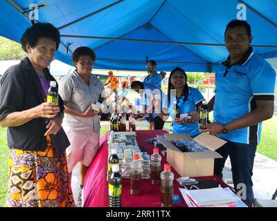 200901 -- SUVA, Sept. 1, 2020 -- Sales personnel promote noni fruit products at an outdoor market event in Suva, Fiji, Aug. 7, 2020. TO GO WITH Feature: A special letter from Fijian company hails growing Chinese market amid COVID-19  FIJI-SUVA-COVID-19-CHINA-MARKET ZhangxYongxing PUBLICATIONxNOTxINxCHN Stock Photo