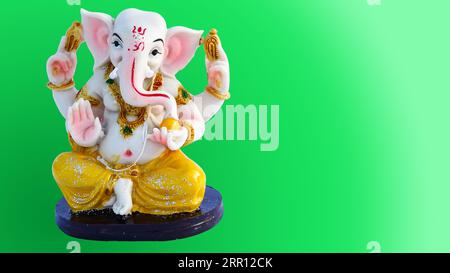 Ganesh Chaturthi festival, Ganpati statue with beautiful texture on greenish background, Lord Ganesha is hindu god of Success. Stock Photo