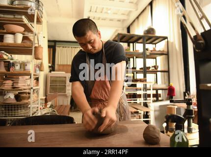 200904 -- HANGZHOU, Sept. 4, 2020 -- Yu Yuanfeng kneads the mud to make pottery in his studio in Hangzhou, east China s Zhejiang Province, Sept. 3, 2020. Yu Yuanfeng, a master degree graduate in ceramic art of China Academy of Art, is fascinated by making coffee in different forms of pottery. He resigned from a university after working as a teacher for 11 years and set up a studio in the outskirts of Hangzhou to make various types of pottery to brew coffee.  CHINA-ZHEJIANG-COFFEE-POTTERYCN WengxXinyang PUBLICATIONxNOTxINxCHN Stock Photo