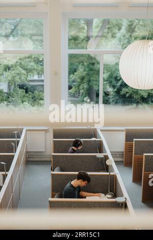 High angle view of male and female students studying in library Stock Photo