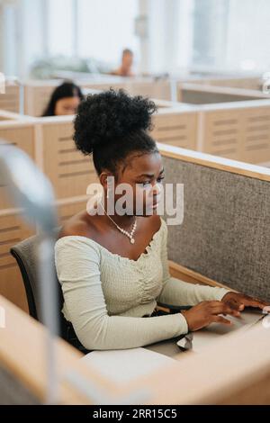 Young woman using laptop while studying at university Stock Photo