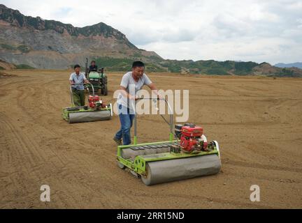 200905 -- QINHUANGDAO, Sept. 5, 2020 -- People sow grass seeds in the field restored from a disused mine in Maquanzi Town of Qinglong Manchu Autonomous County, north China s Hebei Province, Sept. 5, 2020. In recent years, Qinglong Manchu Autonomous County has focused on restoring open pits and reclaimed 8,762 mu about 584 hectares of land.  CHINA-HEBEI-MINE-RESTORATION CN YangxShiyao PUBLICATIONxNOTxINxCHN Stock Photo