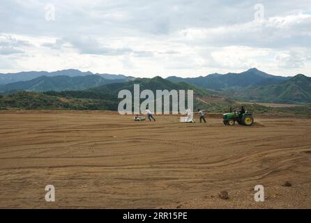 200905 -- QINHUANGDAO, Sept. 5, 2020 -- People sow grass seeds in the field restored from a disused mine in Maquanzi Town of Qinglong Manchu Autonomous County, north China s Hebei Province, Sept. 5, 2020. In recent years, Qinglong Manchu Autonomous County has focused on restoring open pits and reclaimed 8,762 mu about 584 hectares of land.  CHINA-HEBEI-MINE-RESTORATION CN YangxShiyao PUBLICATIONxNOTxINxCHN Stock Photo