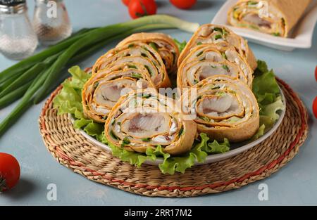 Lavash roll with herring, potatoes and onions on light blue background, closeup Stock Photo