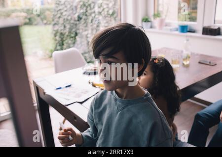 Boy drawing in living room at home Stock Photo