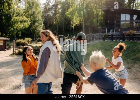 Happy kids having fun while playing with counselors at summer camp Stock Photo
