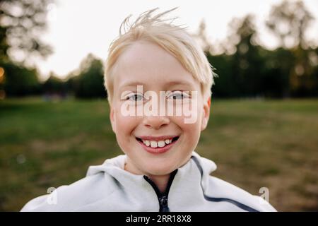 Portrait of smiling blond boy in playground Stock Photo