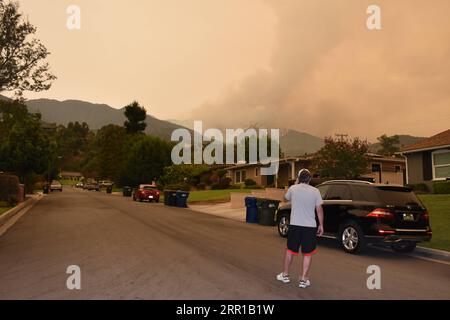 200911 -- LOS ANGELES, Sept. 11, 2020 -- A man watches the wildfire in Angeles National Forest, Monrovia, Los Angeles, the United States, Sept. 10, 2020. Wildfires have scorched a record 3.1 million acres 12,525 square km of land in the U.S. state of California since August, authorities said Thursday.  U.S.-CALIFORNIA-WILDFIRE GaoxShan PUBLICATIONxNOTxINxCHN Stock Photo