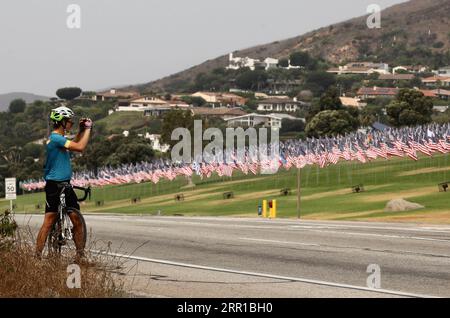200911 -- LOS ANGELES, Sept. 11, 2020  -- A cyclist takes a photo of the Waves of Flags display at Pepperdine University in Malibu, the United States, on Sept. 11, 2020. The Waves of Flags display commemorating the 19th anniversary of the 9/11 attacks was not open to the public this year due to the COVID-19 pandemic.  U.S.-MALIBU-9/11 ATTACKS-19TH ANNIVERSARY Xinhua PUBLICATIONxNOTxINxCHN Stock Photo