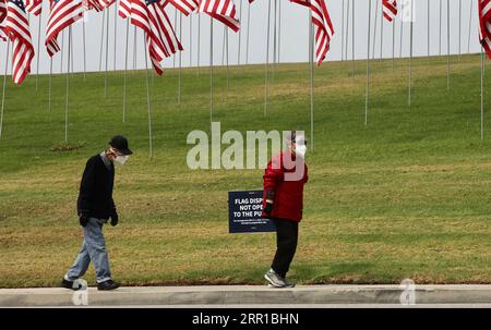 200911 -- LOS ANGELES, Sept. 11, 2020  -- People wearing face masks walk past the Waves of Flags display at Pepperdine University in Malibu, the United States, on Sept. 11, 2020. The Waves of Flags display commemorating the 19th anniversary of the 9/11 attacks was not open to the public this year due to the COVID-19 pandemic.  U.S.-MALIBU-9/11 ATTACKS-19TH ANNIVERSARY Xinhua PUBLICATIONxNOTxINxCHN Stock Photo
