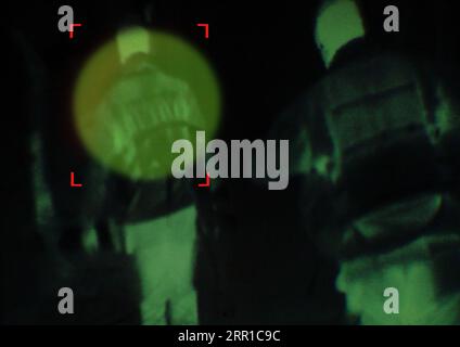 Military, enemy and target in night vision, overlay or dark green silhouette of spy, agent or terrorist risk to soldier. Police, surveillance and Stock Photo