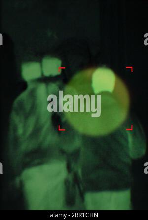 Military, enemy and target in night vision, overlay or dark green silhouette of spy, agent or terrorist risk to soldier. Police, surveillance and Stock Photo
