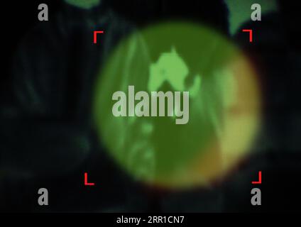 Military, enemy and target in night vision, overlay or dark green silhouette of spy, agent or terrorist risk to soldier. Police, surveillance and Stock Photo