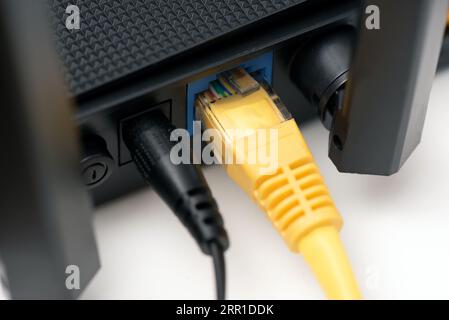 Network cables connected to a router or modem Stock Photo