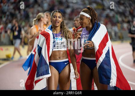 Amber Anning and Nicole Yeargin with her country's flag in the 4x400 meter relay at the World Athletics Championships in Budapest Stock Photo