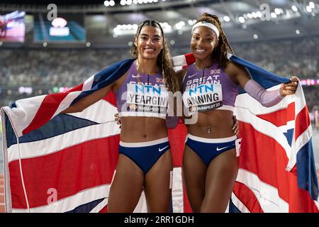 Amber Anning and Nicole Yeargin with her country's flag in the 4x400 meter relay at the World Athletics Championships in Budapest Stock Photo