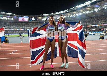 Amber Anning and Nicole Yeargin with her country's flag in the 4x400 meter relay at the World Athletics Championships in Budapest Stock Photo