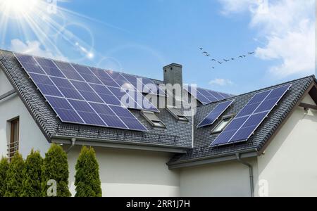 Eco-Friendly House with Solar Panels on Gable Roof Stock Photo