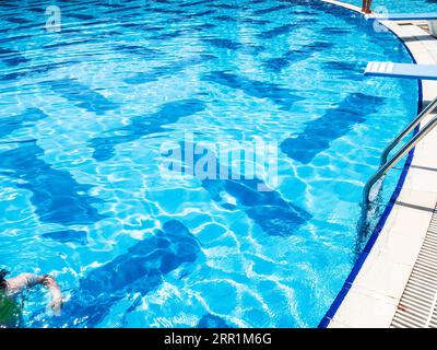 blue water in outdoor swimming pool on sunny summer day Stock Photo