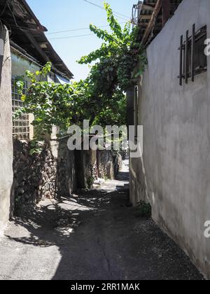 old narrow stone street between houses in Kond quarter of Kentron District of Yerevan city, Armenia Stock Photo