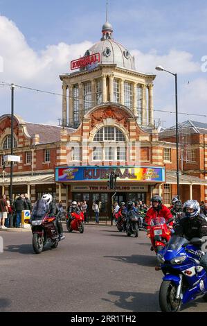 Group of bikers, riders at the Southend Shakedown 2007 motorcycle rally, Southend on Sea, Essex, UK. Passing the historic Kursaal, old amusement park Stock Photo