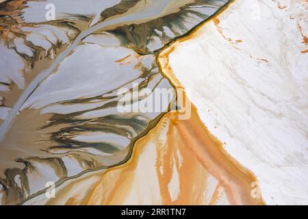 Abstract background of marble surface with uneven rough lines natural rock texture in orange and white colors Stock Photo