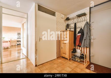 Corridor of contemporary apartment with black closets and doorway leading Stock Photo