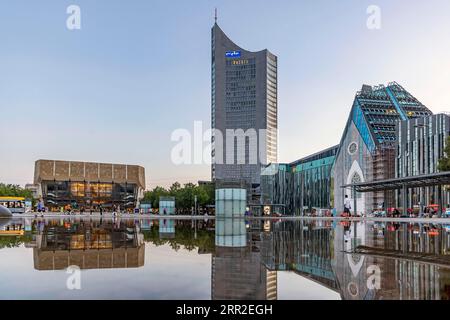 City view of Leipzig in the evening, University with Paulinum, Alma Mater Lipsiensis, Gewandhaus with Mendebrunnen, MDR, Leipzig, Saxony, Germany Stock Photo