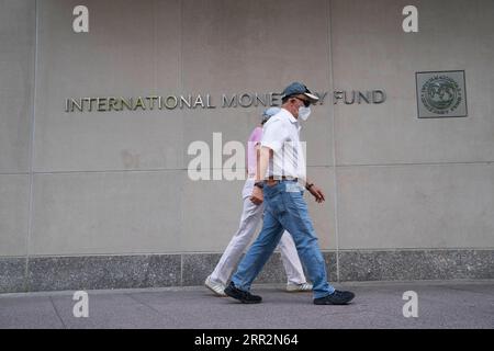 201015 -- WASHINGTON, Oct. 15, 2020 -- People walk past the headquarters of the International Monetary Fund IMF in Washington D.C., the United States, July 17, 2020.  Xinhua Headlines: World economy faces difficult climb amid pandemic, with China s growth as beam of hope LiuxJie PUBLICATIONxNOTxINxCHN Stock Photo