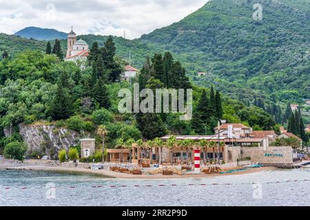 Lighthouse and beach restaurant in the small coastal town of Jošice at the southern point of the Verige Strait on the Bay of Kotor in Montenegro Stock Photo