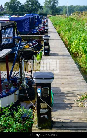 Shoreline charging bollards located in a marina on the canal system in Cheshire, UK used to connect narrowboats to a power supply. Stock Photo