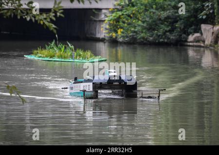 201021 -- HANGZHOU, Oct. 21, 2020 -- An unmanned patrolling and waste collecting machine works in a river in Hangzhou, east China s Zhejiang Province, Oct. 21, 2020. A series of high-tech measures were applied to improve the river ecosystem in Hangzhou, including unmanned boats patrolling, automatic watercourse waste cleaning system, artificial intelligence AI monitoring system, etc.  CHINA-HANGZHOU-RIVER ECOSYSTEM-MANAGEMENT CN XuxYu PUBLICATIONxNOTxINxCHN Stock Photo