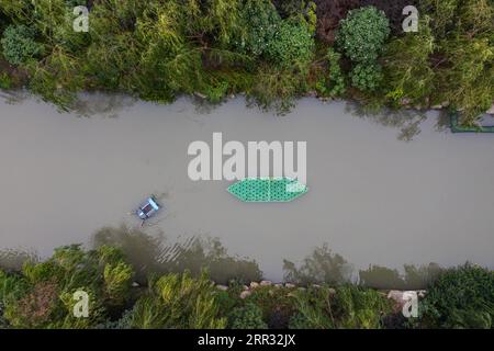 201021 -- HANGZHOU, Oct. 21, 2020 -- Aerial photo taken on Oct. 21, 2020 shows an unmanned patrolling and waste collecting machine works in a river in Hangzhou, east China s Zhejiang Province. A series of high-tech measures were applied to improve the river ecosystem in Hangzhou, including unmanned boats patrolling, automatic watercourse waste cleaning system, artificial intelligence AI monitoring system, etc.  CHINA-HANGZHOU-RIVER ECOSYSTEM-MANAGEMENT CN XuxYu PUBLICATIONxNOTxINxCHN Stock Photo