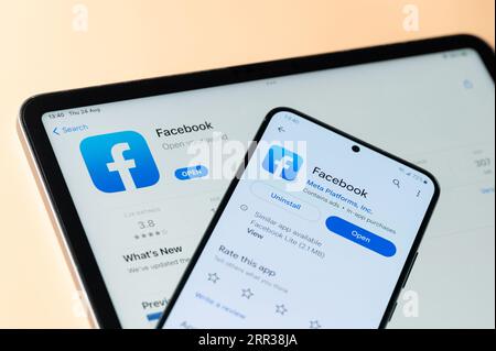 New York, USA - August 24, 2023: Facebook app on Ipados and google store on smartphone and ipad screen close up view Stock Photo