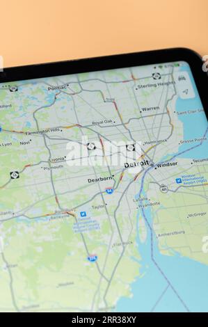 New York, USA - August 24, 2023: Car traffic in Detroit on google maps app on tablet screen close up view Stock Photo