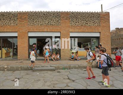 Pompei, Italy - June 25, 2014: Hungry Tourists at Autogrill Fast Food Restaurant in Ancient Roman Ruins of Pompei. Stock Photo